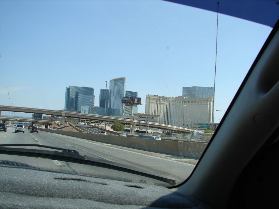 Highway view of Las Vegas skyline with casinos and tall buildings