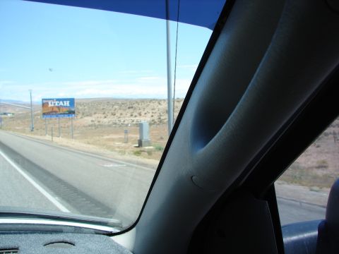 1992 Ford Taurus - Driving through Utah, a billboard for the state is visible from the highway.