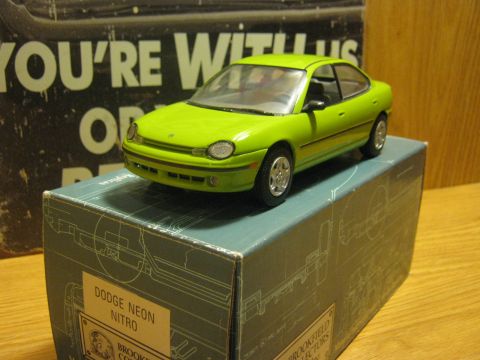 2010 Mitsubishi Outlander - A green Dodge Neon Nitro model car sits atop its display box, which features technical diagrams.