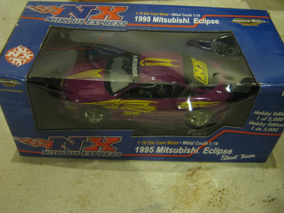 Purple 1995 Mitsubishi Eclipse toy car with yellow graphics in a blue box
