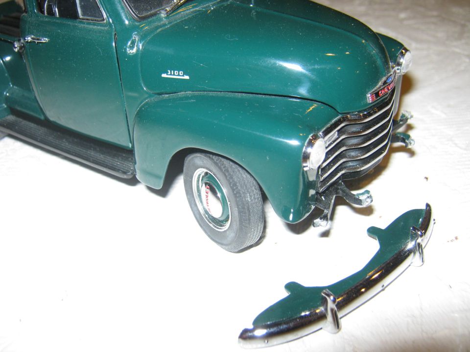 Green 1950s Chevrolet 3100 pickup truck front view with detached bumper