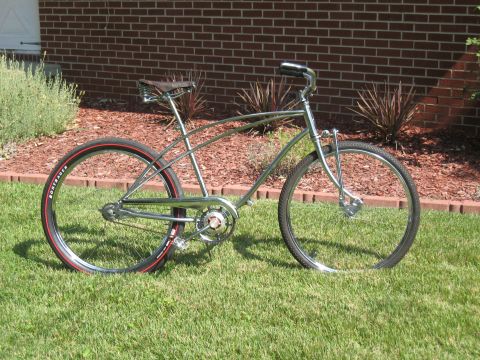 1994 Ford Bronco - A bicycle is parked on a grassy area with a brick wall in the background.