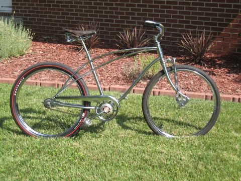 1994 Ford Bronco - This cruiser bicycle has a chrome frame, red-striped tires, and a brown leather seat.