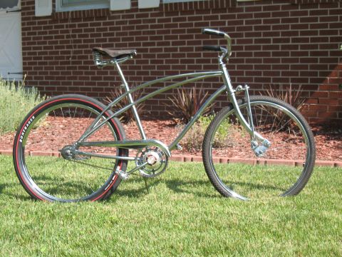 1994 Ford Bronco - A vintage-style bicycle with a chrome frame and red-striped tires sits on a lawn.