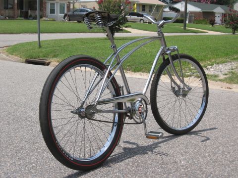 1994 Ford Bronco - A shiny cruiser bicycle with a spring-loaded seat is shown from the side on an asphalt road.