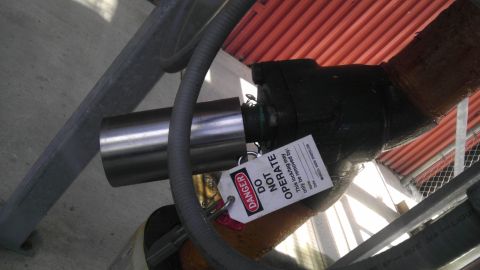 1989 Ford Bronco - A lock-out tag is affixed to industrial piping, indicating that the equipment should not be operated.