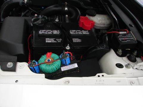 1992 Ford Taurus - Custom wiring and dual batteries are visible in the engine bay, with a toroidal transformer and blue capacitors.