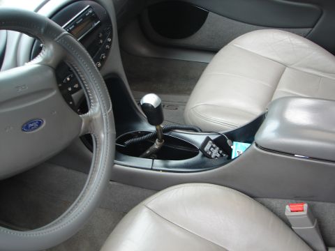 1992 Ford Taurus - Interior view of a car, leather seats, steering wheel, and center console. Text from a watermark is visible.
