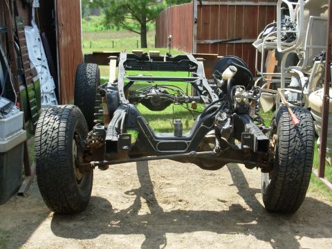 1983 Ford Bronco - Back on 4 wheels! I don't expect that bottle of anti-seize on the engine crossmember to last thru the assembly process.