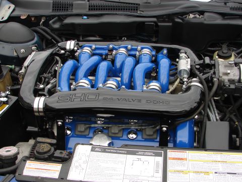 1992 Ford Taurus - Close-up of the engine bay, highlighting the SHO 24 VALVE DOHC engine components with vibrant blue intake runners.