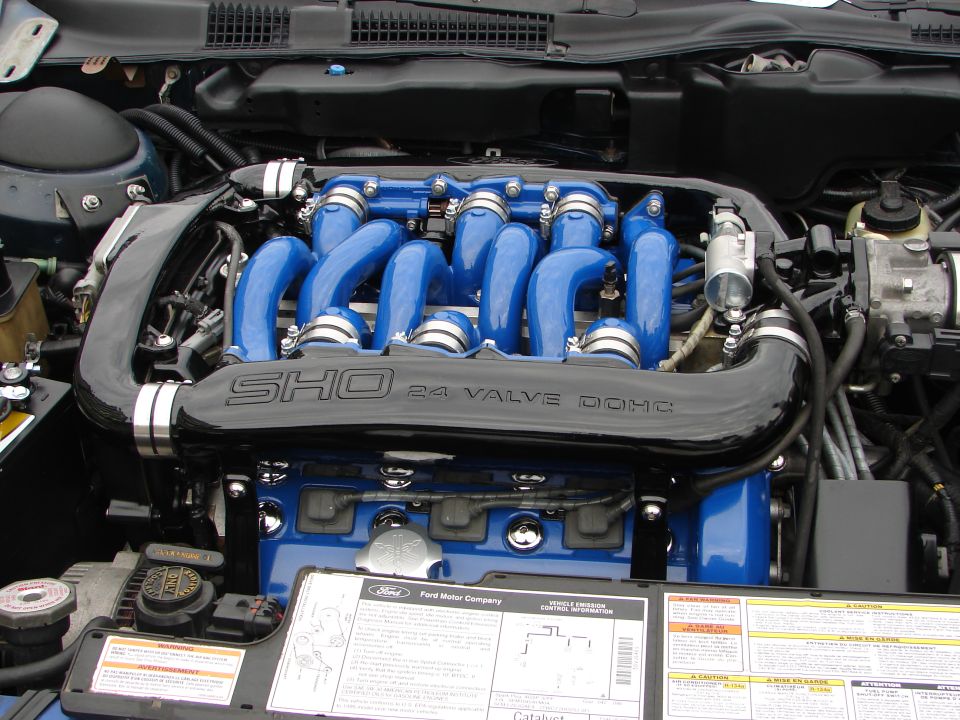 Engine bay with blue intake runners and SHO 24 VALVE DOHC branding