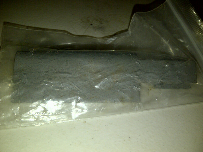 Gray rectangular part in plastic packaging