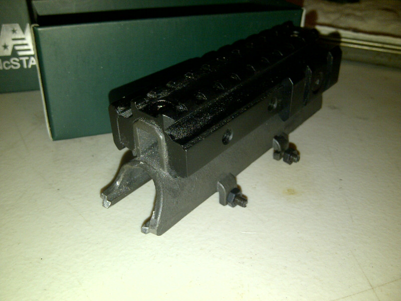 Black metal part with rails and mounting hardware