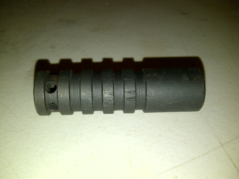 Black metal part with ridges and two holes on one end
