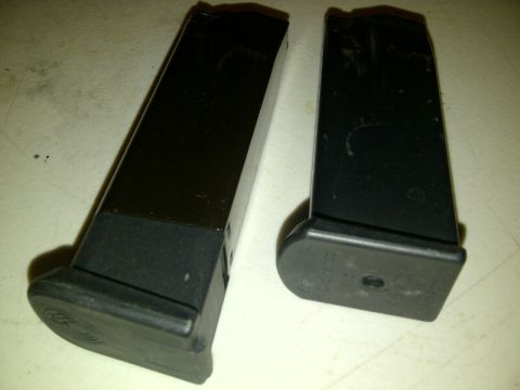 1989 Ford Bronco - Two pistol magazines are shown side-by-side on a flat surface.