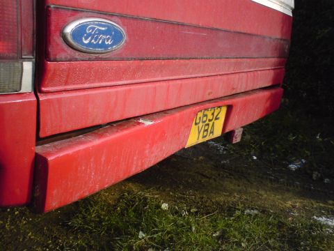 1989 Ford Bronco - Rear view of a red 1989 Ford Bronco, showing the Ford emblem and license plate.