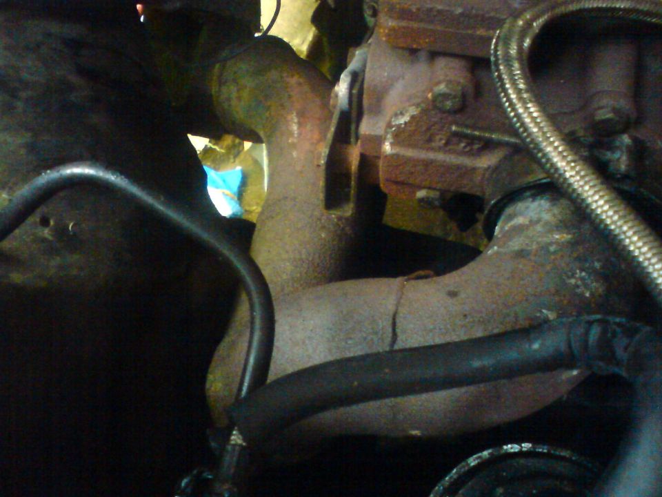 close-up of rusty exhaust pipes and engine block