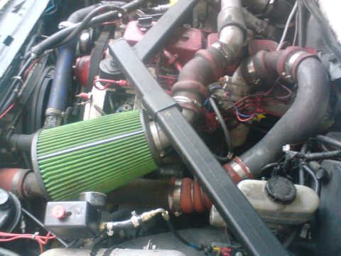 1989 Ford Bronco - The engine bay features an aftermarket air intake system and custom piping.