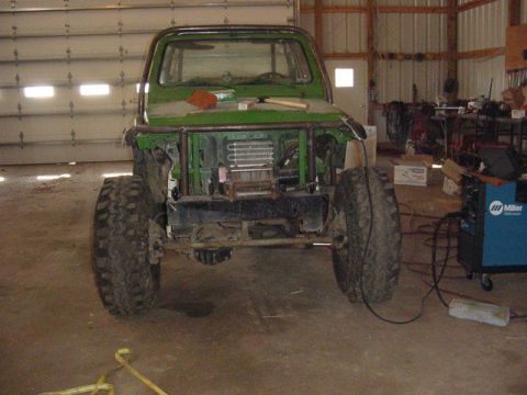 1992 Ford Bronco - Off-road vehicle undergoing modifications in a workshop setting.
