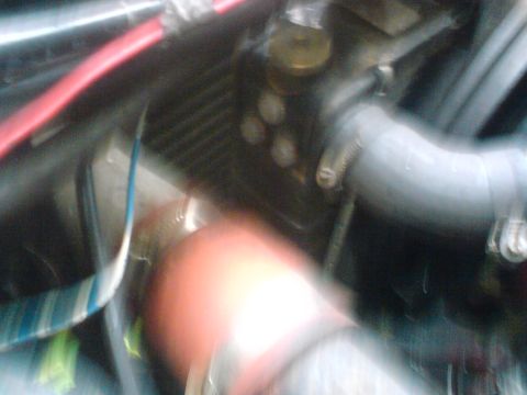 1989 Ford Bronco - Close-up view of engine bay components, including hoses and radiator fins, with a watermark at the bottom.