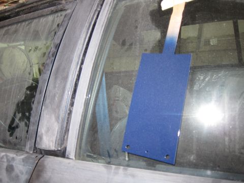 1991 Ford LTD Crown Victoria - A blue card is taped to the dusty interior window of a car.