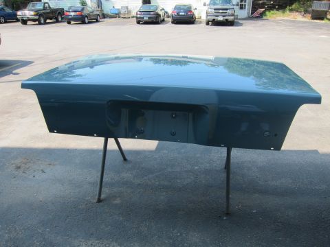 1991 Ford LTD Crown Victoria - Teal car trunk lid, likely from a sedan, displayed on a stand outdoors.