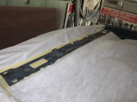 1991 Ford LTD Crown Victoria - A car part is covered with paper and tape, possibly for protection or preparation.