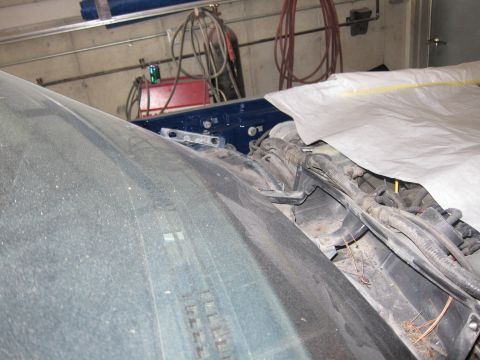 1991 Ford LTD Crown Victoria - View of the engine bay and windshield of a vehicle, partially covered by a tarp.