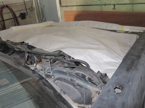 1991 Ford LTD Crown Victoria - Car's engine bay and hood are covered with a white protective sheet, revealing some wiring and parts.