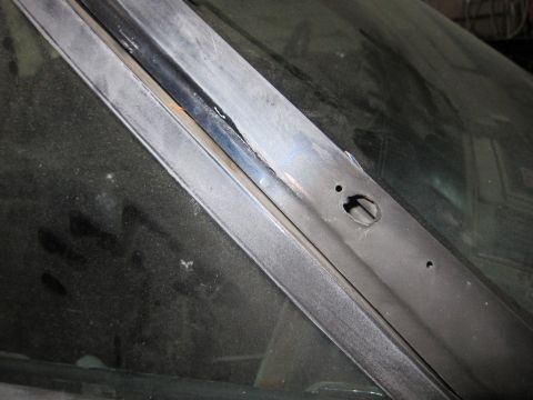 1991 Ford LTD Crown Victoria - Close-up view of the windshield trim and surrounding metalwork on a vehicle.