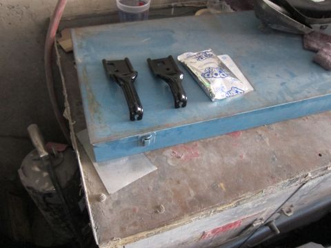 1991 Ford LTD Crown Victoria - Two black metal brackets and a Pop Rocks candy packet are on a blue toolbox.