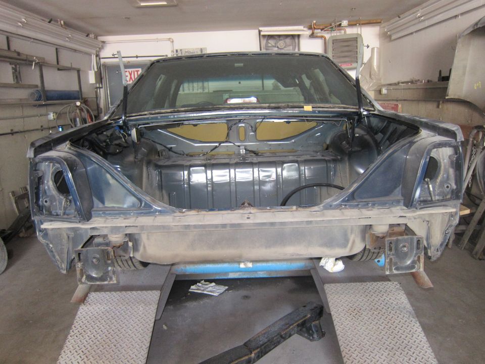 1991 Ford Crown Victoria LTD rear trunk area on a lift, dark blue, disassembled