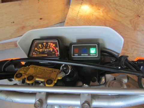 1968 Ford Mustang - The dashboard of a motorcycle displays its gauges and indicator lights, with a novelty keychain attached to the ignition.