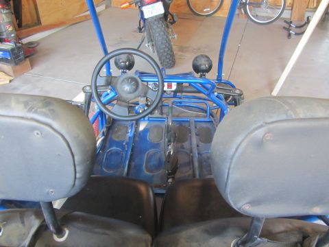 1968 Ford Mustang - Interior view of a blue buggy, showing the steering wheel, seats, and pedals.