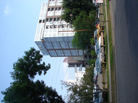 1992 Ford Taurus - A row of parked cars is visible along a street with a large building in the background.