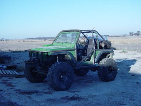 1992 Ford Bronco - This heavily modified off-road vehicle has a custom roll cage and oversized tires, suggesting it is not a stock 1992 Ford Bronco.