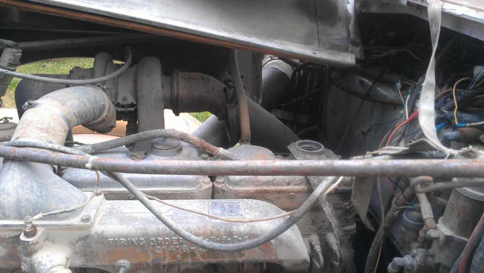 Close-up of a truck engine showing turbochargers, pipes, and wiring. 'FIRING ORDER' is visible on the engine block