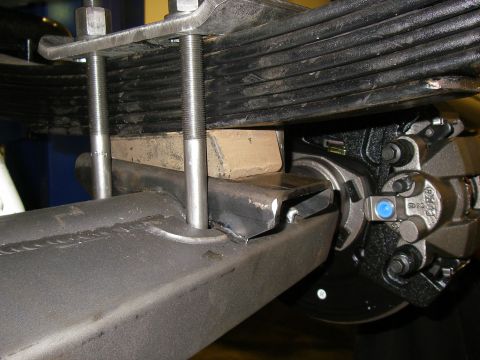 1990 Ford Bronco - Close-up view of a vehicle's rear suspension and braking components.