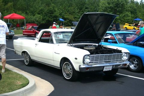 1976 Ford Ranchero - A white 1976 Ford Ranchero pickup truck is displayed with its hood open at an outdoor car show.