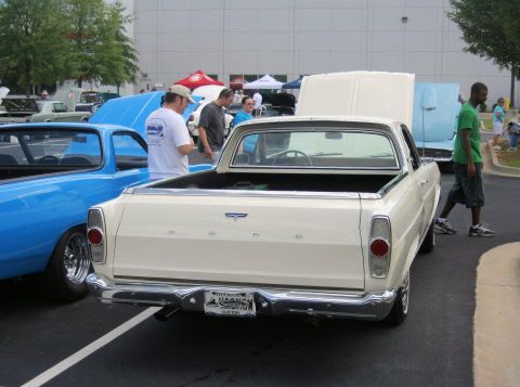 1976 Ford Ranchero - A white 1966 Ford Ranchero is parked next to a blue vehicle at an outdoor car show.