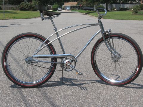 1994 Ford Bronco - Chrome cruiser bicycle with red-striped tires and black sprung seat parked on asphalt.