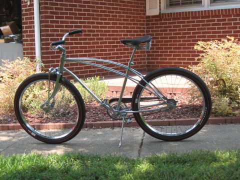 1994 Ford Bronco - Cruiser bicycle with chrome frame and wide tires sits on a concrete path.