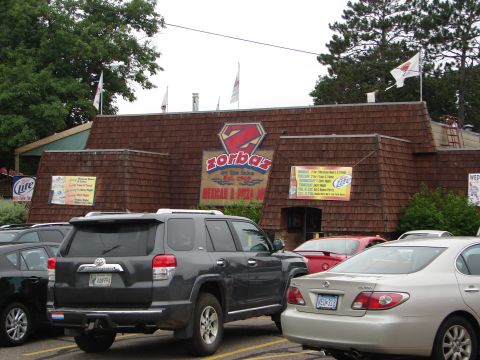 1992 Ford Taurus - Cars parked in front of Zorba's Mexican & Pizza restaurant.