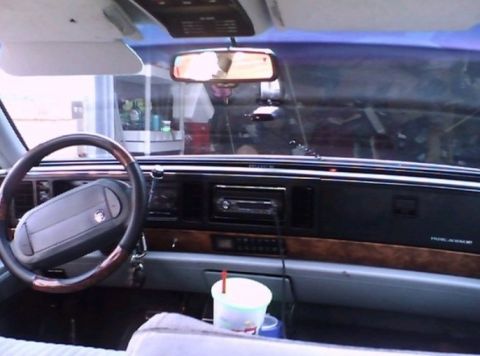 2000 Mercury Grand Marquis - Interior view of a car, likely from the mid-1990s, with a cup holder and drink visible.