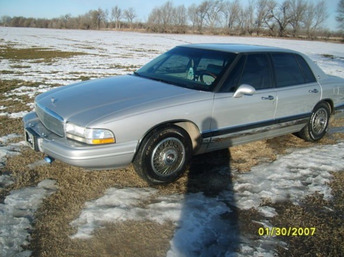 Silver sedan parked in a snowy field