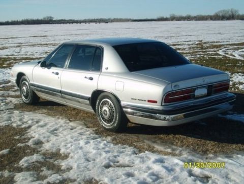 2000 Mercury Grand Marquis - A silver Buick Park Avenue is parked in a field with snow on the ground.