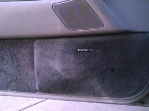 2000 Mercury Grand Marquis - The interior door panel features a speaker grille and a "CONCERT SOUND II" badge, indicating an audio system upgrade.