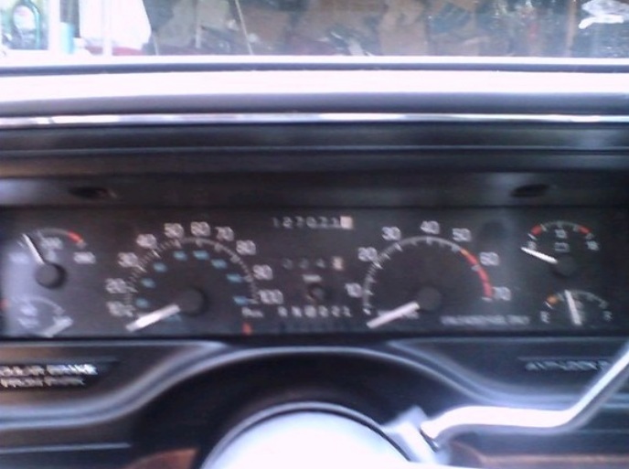 Dashboard gauges with odometer reading 127021, speedometer, and fuel gauge