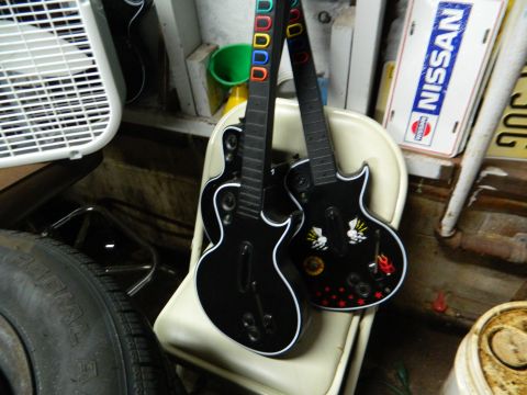 1995 Honda Civic - A pair of toy guitars are propped up on a chair, with various items in the background.
