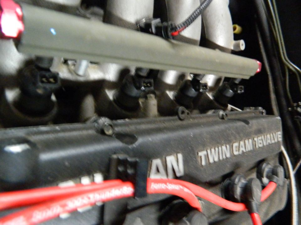Nissan Twin Cam 16 Valve engine with red spark plug wires